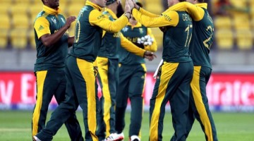 South Africa's Rilee Rossouw and de Villiers celebrate the dismissal of United Arab Emirates' Mohammad Naveed during their Cricket World Cup match in Wellington